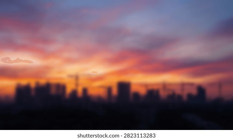 Dramatic clouds illuminated by the setting sun create a breathtaking spectacle above a dark, urban skyline.