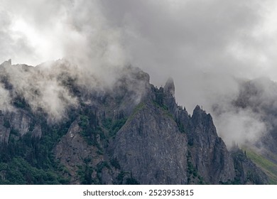 Dramatic clouds with mist and mountain peaks, Tongass national forest, Misty Fjords national monument, Alaska, USA. - Powered by Shutterstock