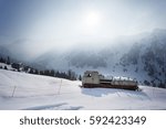 Dramatic clouds with mountain, tree and old snowcat in the evening shot