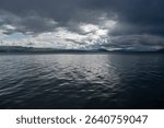 Dramatic Clouds Over a Calm Mountain Lake