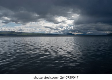 Dramatic Clouds Over a Calm Mountain Lake - Powered by Shutterstock - Get 15% off with code: PIKWIZARD15
