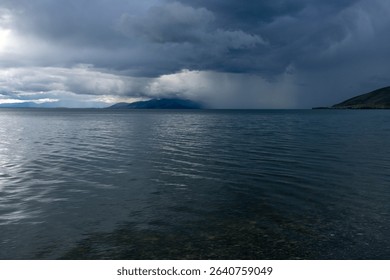 Dramatic Clouds Over a Calm Mountain Lake