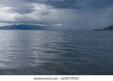 Dramatic Clouds Over a Calm Mountain Lake - Powered by Shutterstock - Get 15% off with code: PIKWIZARD15