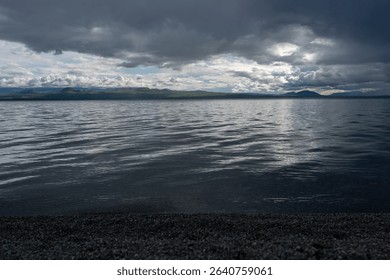 Dramatic Clouds Over a Calm Mountain Lake