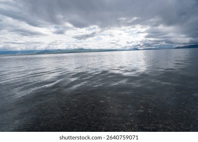 Dramatic Clouds Over a Calm Mountain Lake