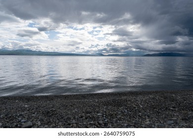 Dramatic Clouds Over a Calm Mountain Lake
