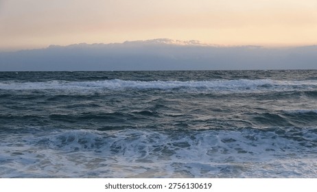 Dramatic clouds over the dark blue ocean horizon during an early morning sunrise in South Korea

A wide-angle view of the East Sea with layered clouds catching the first light of dawn above the restless ocean waves.