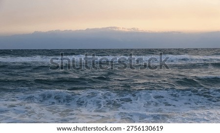 Dramatic clouds over the dark blue ocean horizon during an early morning sunrise in South Korea

A wide-angle view of the East Sea with layered clouds catching the first light of dawn above the restless ocean waves.