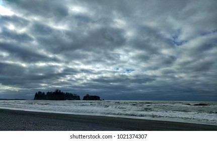 dramatic clouds over sea stacks and waves