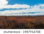 dramatic clouds partially covering Mt Mckinley in DEnali national park taken during autumn.	