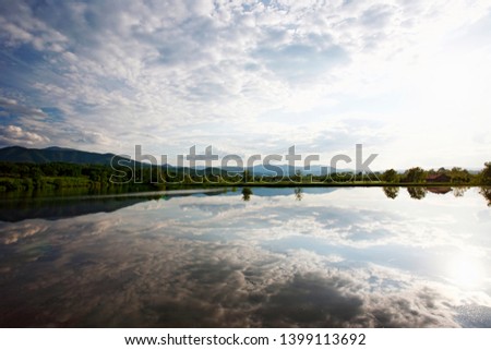 Dramatic clouds with reflection on lake