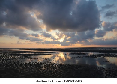 Dramatic clouds sunset at Belgian coast