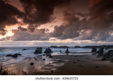 Dramatic clouds and sunset over Face Rock Beach in Bandon, Southern Oregon, USA