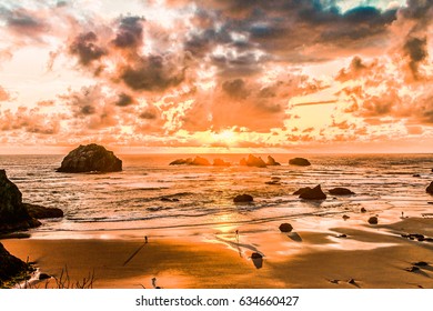 Dramatic clouds and sunset over the Pacific Ocean, Face Rock Beach State Park in Bandon, Oregon, USA.