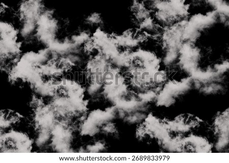 Dramatic clouds swirl against a dark contrasting sky creating a captivating and ethereal atmosphere
