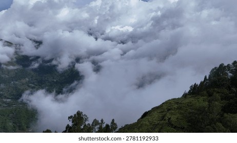 Dramatic Clouds Veil Lush Mountain Range and Valleys