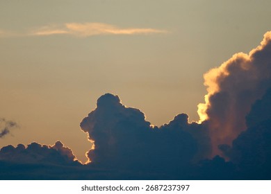 Dramatic clouds with a warm sunset glow and a clear sky create a serene evening atmosphere.