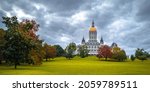 Dramatic cloudscape and autumn landscape over Connecticut State Capital building in Bushnell Park in Hartford, Connecticut