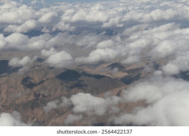 Dramatic cloudscape and China landscape with the mountains from the airplane's window