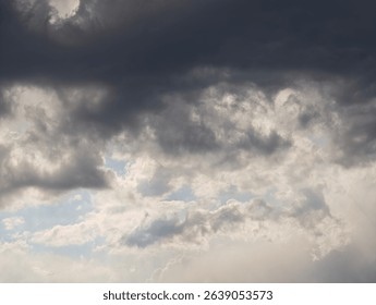 Dramatic cloudscape with dark and light clouds creating a moody atmosphere