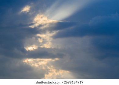 A Dramatic Cloudscape Depicting Rays of Light Poised to Break Through the Overarching Sky