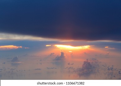 Dramatic cloudscape during sunset from the airplane's window