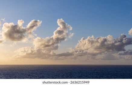 Dramatic cloudscape illuminating the Pacific Ocean with warm sunlight beneath a vibrant sky.