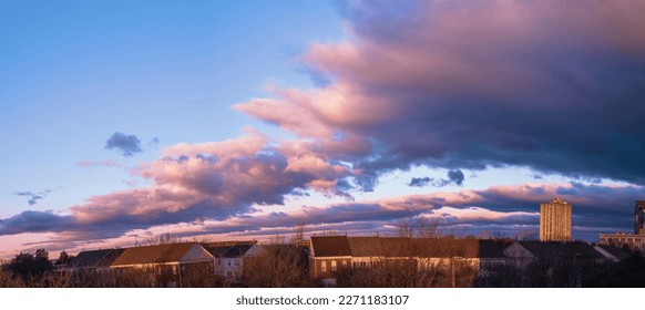 Dramatic cloudscape over the barren trees and houses after winter rain storm in Gaithersburg, Maryland
