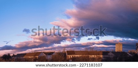 Dramatic cloudscape over the barren trees and houses after winter rain storm in Gaithersburg, Maryland
