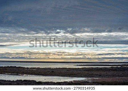 Dramatic cloudscape over coastal waters at sunset in Akranes, Iceland