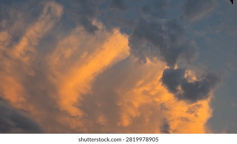 Dramatic cloudscape over farmland at sunset