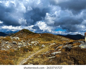 Dramatic cloudscape over hilly rocky terrain