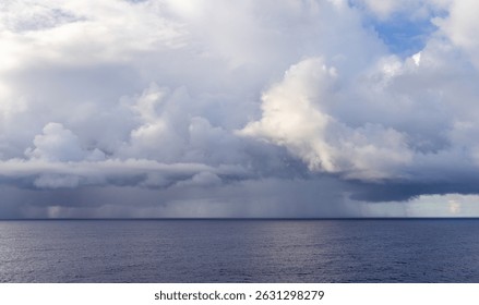 Dramatic cloudscape with serene ocean view during a tranquil stormy moment.