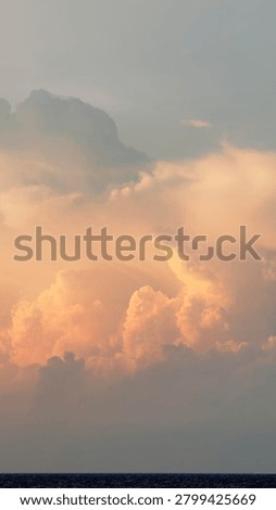 A Dramatic Cloudscape with an Shinny Abstract Cloud in the Middle of the Ocean