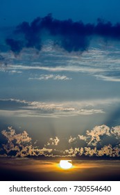 Dramatic cloudscape, sun setting through clouds