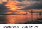 Dramatic cloudscape at sunrise over Claiborne Pell Newport Bridge on Route 138 in Rhode Island