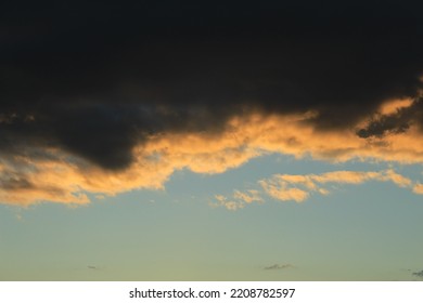 Dramatic Cloudscape At Sunset With Dark Clouds And A Clear Blue Sky. Concept For Hard Roads Ahead Or Clouds With Silver Lining. Concept For Changing Mind, New Horizon, New Day, Changing Circumstances