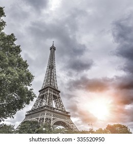 Dramatic cloudy sky above Eiffel Tower in Paris, France. Toned photo.