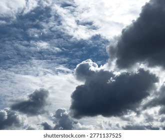 Dramatic cloudy sky with bright light and dark storm clouds. Dense cloud cover fills the frame with strong contrast and atmospheric mood. Ideal for weather backgrounds, nature concepts, and