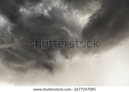 Dramatic cloudy sky with dark storm clouds and overcast atmosphere, heavy rain threatening weather, moody sky scene showing turbulent weather conditions.