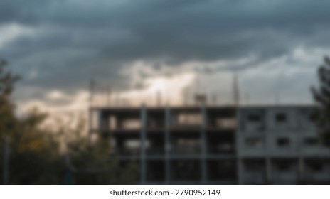 A dramatic cloudy sky hangs over a construction site during the golden hour, creating a moody atmosphere. The building is under construction.