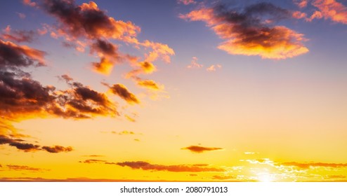 Dramatic cloudy sky illuminated by the rays at sunset or sunrise.  