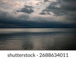 Dramatic cloudy sky over calm lake horizon at dusk  
Storm clouds above tranquil water – moody landscape scene  
Serene lake view with layered clouds and soft reflections  
Peaceful Balaton scenery 
