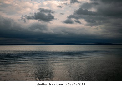 Dramatic cloudy sky over calm lake horizon at dusk  
Storm clouds above tranquil water – moody landscape scene  
Serene lake view with layered clouds and soft reflections  
Peaceful Balaton scenery 