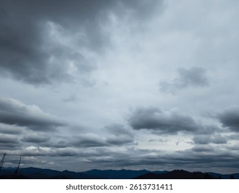 Dramatic cloudy sky over the distant Carpathian Mountains near Slavsko, Ukraine. Moody and atmospheric, suggesting changing weather. Ideal for weather, nature, and travel concepts.