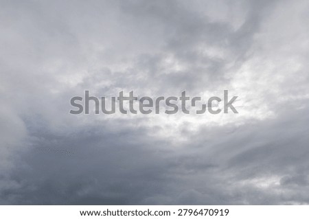 Dramatic cloudy sky over Giant's Causeway with thick cloud layers above the basalt coastline.