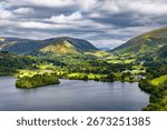 Dramatic cloudy sky over the green hills and lake at Grasmere, Lake District, England