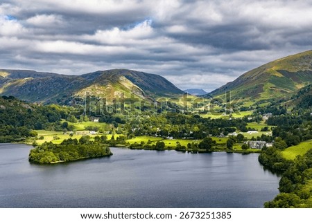 Dramatic cloudy sky over the green hills and lake at Grasmere, Lake District, England