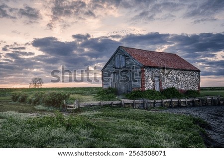 Dramatic cloudy sunset at Thorham Barn