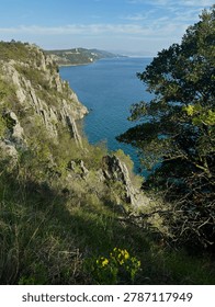 Dramatic coastal cliffs dropping vertically into the deep blue ocean water